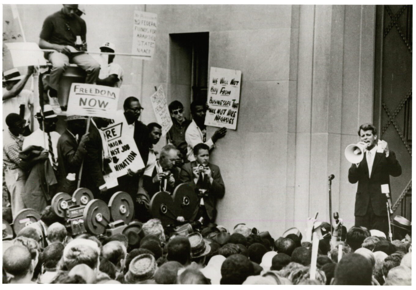 RFK speaking through a bullhorn at a Civil Rights protest